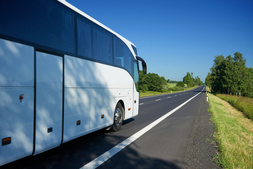 A White Charter Bus On Road | Tour Bus Hire Northern Rivers 