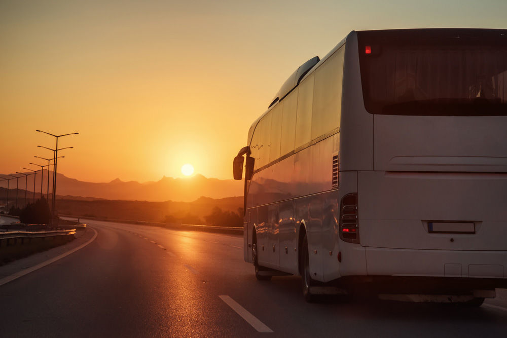 White Bus Driving On Road